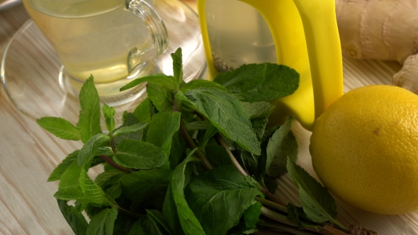 Ginger Tea with Lemon, Mint and Honey on Wooden Background.