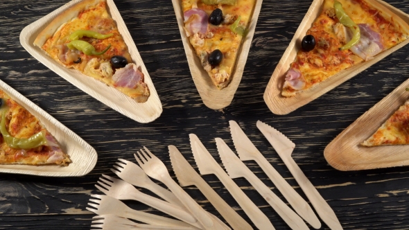 Slices of Pizza on Wooden Plates. Party Concept.