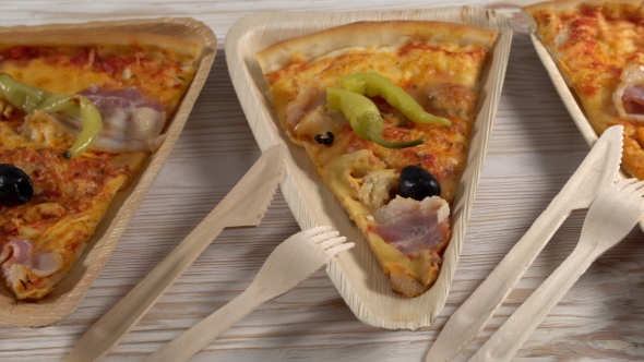 Slices of Pizza on Wooden Plates. Party Concept.