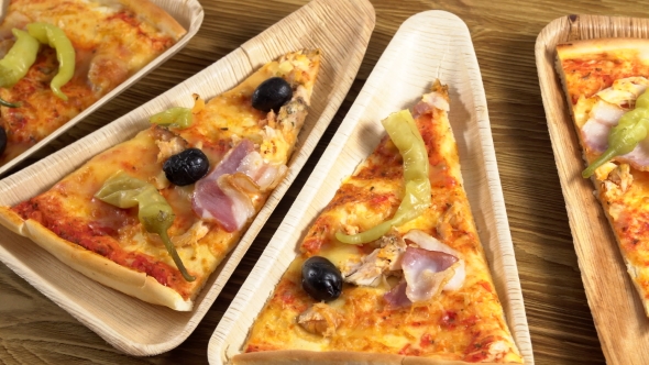 Slices of Pizza on Wooden Plates. Party Concept.