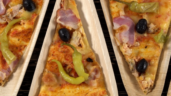 Slices of Pizza on Wooden Plates. Party Concept.