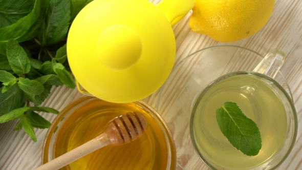 Ginger Tea with Lemon, Mint and Honey on Wooden Background.