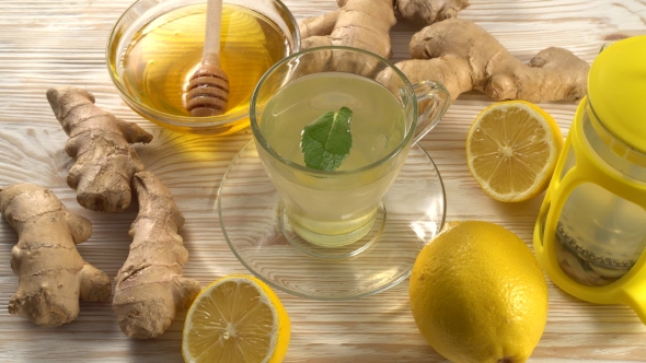 Ginger Tea with Lemon, Mint and Honey on Wooden Background.