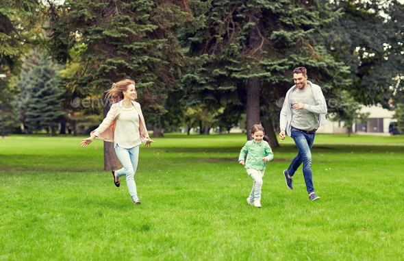happy family walking in summer park - Stock Photo - Images