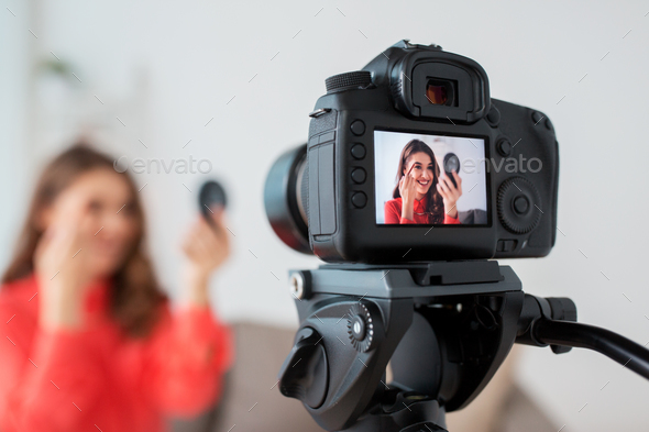 woman with eyebrow pencil recording video at home - Stock Photo - Images