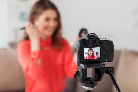 woman with bronzer and camera recording video - Stock Photo - Images