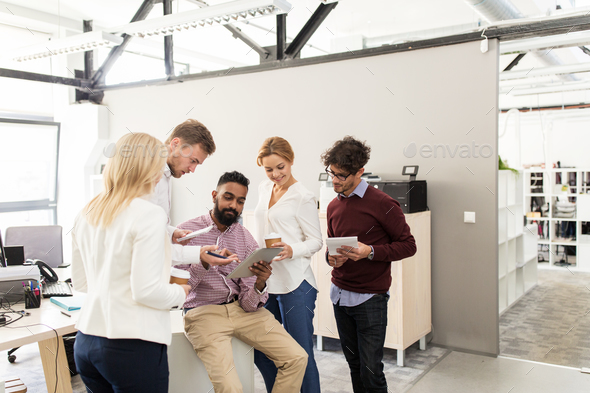 business team with tablet pc and coffee at office - Stock Photo - Images
