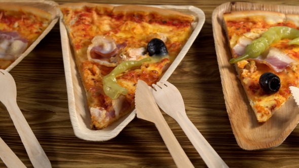 Slices of Pizza on Wooden Plates. Party Concept.