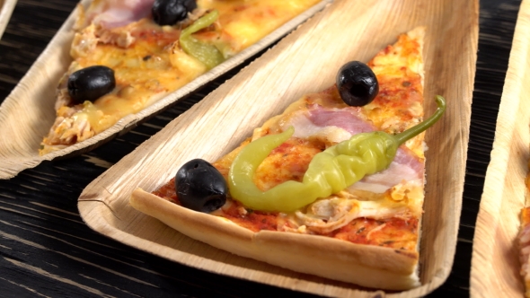 Slices of Pizza on Wooden Plates. Party Concept.