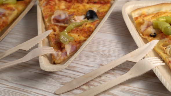 Slices of Pizza on Wooden Plates. Party Concept.