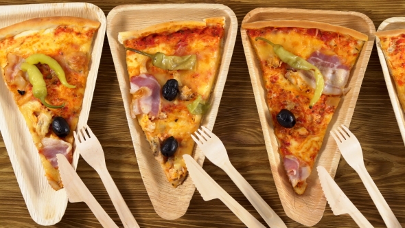 Slices of Pizza on Wooden Plates. Party Concept.