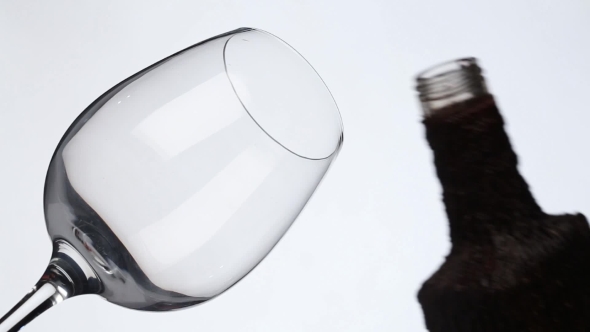 Wine Is Pouring Into a Glass From a Rustic Bottle alt