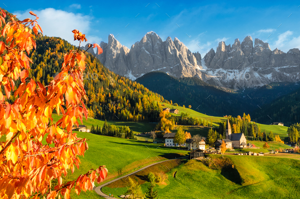Village in a Dolomite landscape in autumn - Stock Photo - Images
