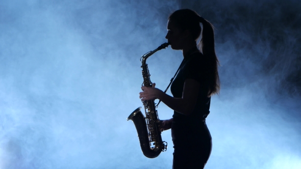 Silhouette Professional Musician Female Playing on Saxophone. Smoky Isolated Studio alt