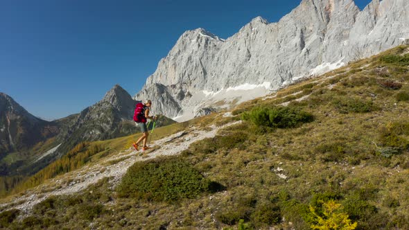 Drone Following Hiking Woman From the Side alt