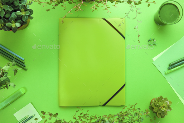 Green Concept of a Folder And Office Supplies On Desk - Stock Photo - Images