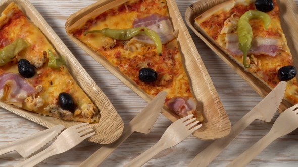 Slices of Pizza on Wooden Plates. Party Concept.