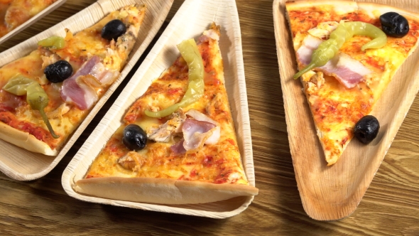 Slices of Pizza on Wooden Plates. Party Concept.