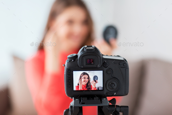 woman with eyebrow pencil recording video at home - Stock Photo - Images