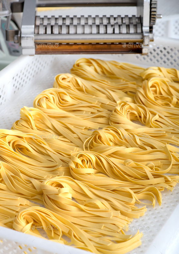 Freshly made Italian fettuccine pasta on a tray - Stock Photo - Images