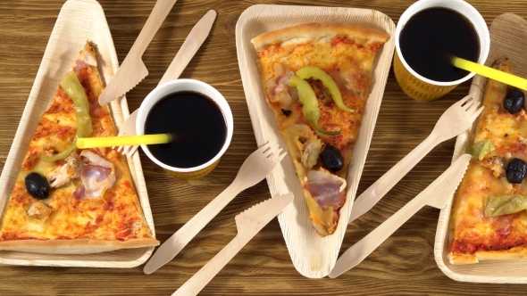 Slices of Pizza on Wooden Plates. Party Concept.