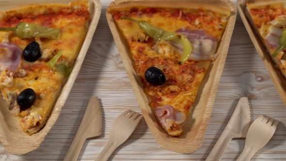 Slices of Pizza on Wooden Plates. Party Concept.