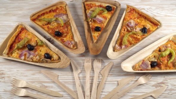 Slices of Pizza on Wooden Plates. Party Concept.