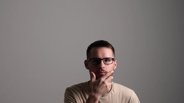 Creative Male Person Thinking, Stroking his Beard, and Getting an Idea alt