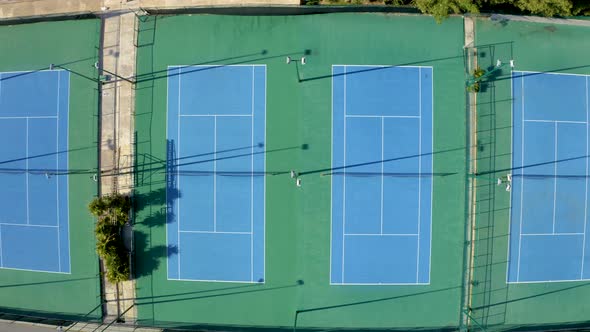 Aerial View of Blue Tennis Courts on an Artificial Grass alt