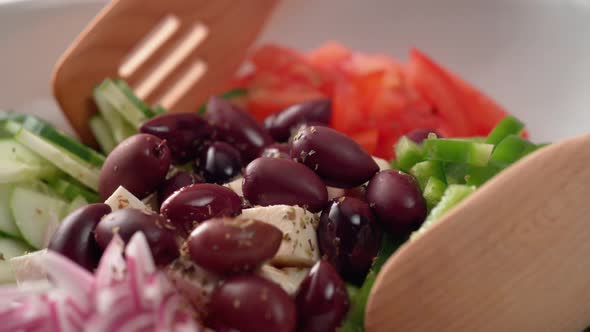 Camera follows tossing greek salad. Slow Motion. alt