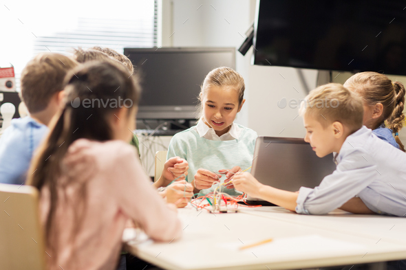 happy children with laptop at robotics school - Stock Photo - Images