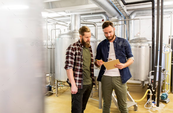 men with clipboard at craft brewery or beer plant - Stock Photo - Images