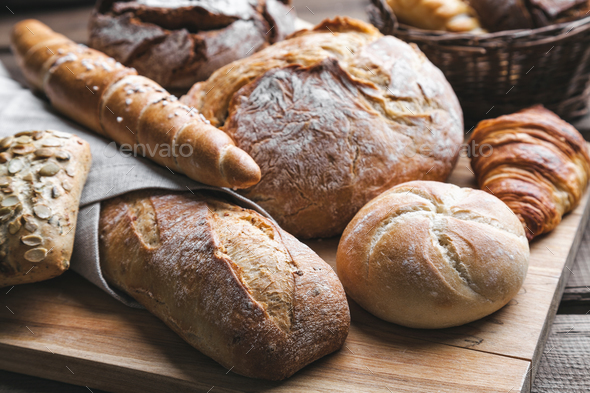 Delicious fresh bread on wooden background Stock Photo by tommyandone