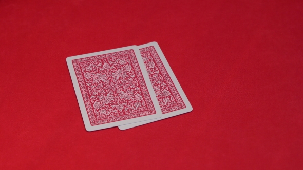 Human Hand Passing Two Cards in Poker Game.