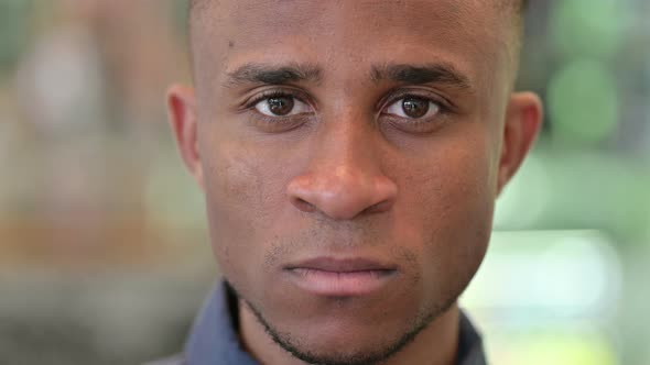 Close Up of Face of Serious Young African Man  alt