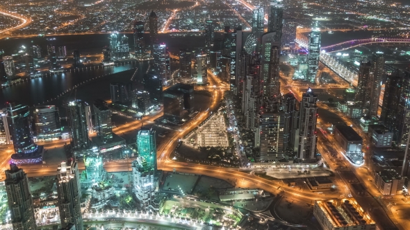 Road in Dubai Downtown with Night Traffic and Illuminated Skyscrapers alt