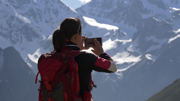 Female Hiker Photographing Mountains