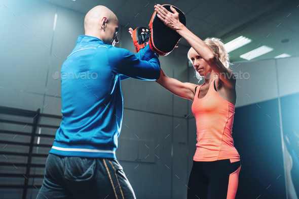 Womens self-defense workout with personal trainer - Stock Photo - Images