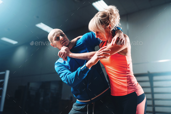 Woman fights with man, self defense technique Stock Photo by NomadSoul1