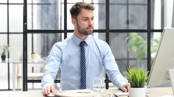 Businessman feels overjoyed looks at computer. Happy man reads good news using PC, business success alt