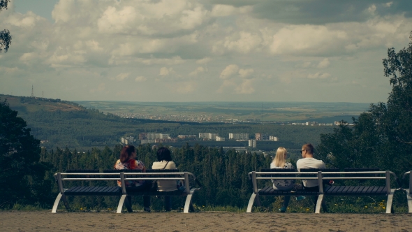 People Sit on Benches with a Beautiful View