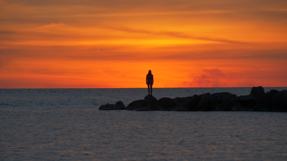 Silhouette of Woman at Sunset at Sea