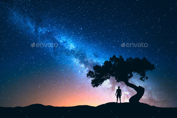 Milky Way, tree and silhouette of alone man. Night landscape - Stock Photo - Images