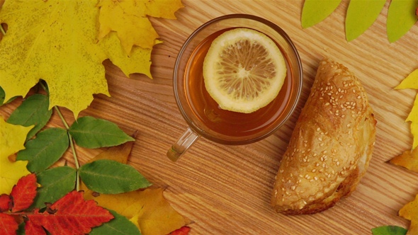 Autumn Tea with Lemon Slice and Croissant. alt