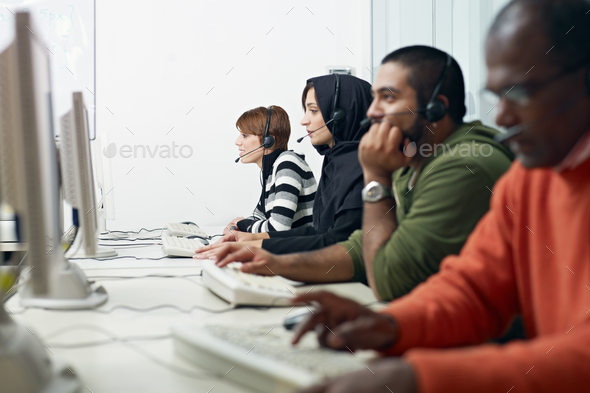 students with headset in computer lab - Stock Photo - Images