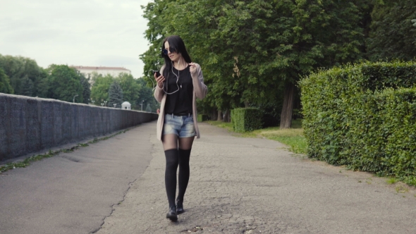 Woman Is Walking in the Park and Dancing