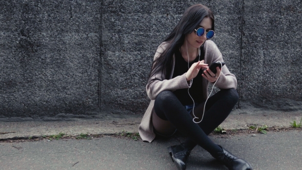 Woman Hipster Sitting on Ground with Smartphone