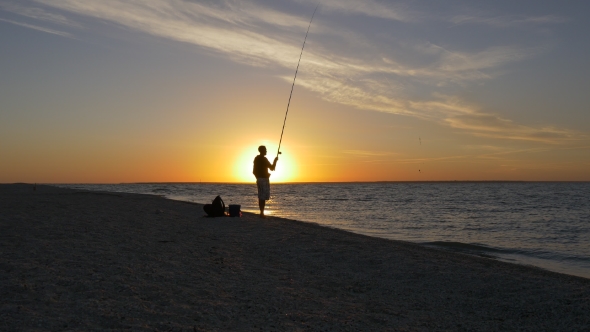Fisherman Throwing Fishing Tackles at Sunrise