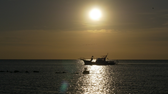 Passenger Boat in Sea at Sunset