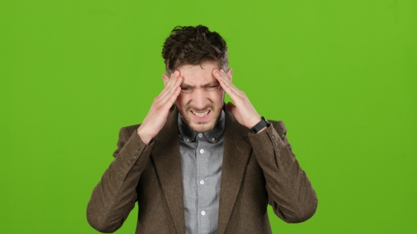 Guy Is Suffering, His Head Hurts, He Is Tired. Green Screen alt